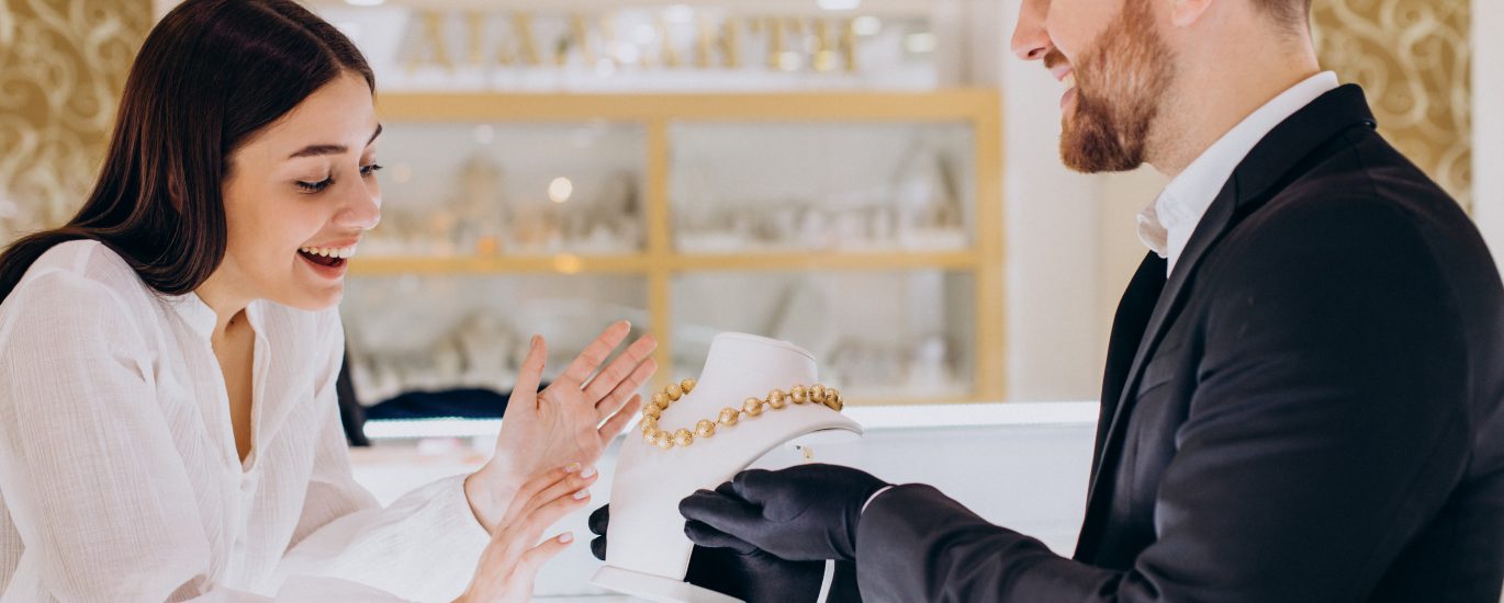 Woman choosing a necklace at jewelry store
